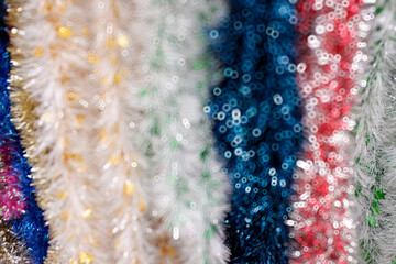 Bokeh of New Year's tinsel, bright background.