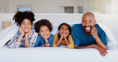 Happy, portrait and children with parents in bed of modern home for bonding together with love....
