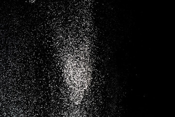 Flour sifting on a black background. White powder splash isolated on black background. Explosive...