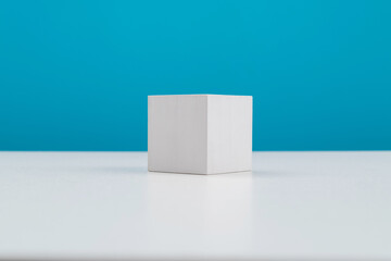Single wooden cube on table