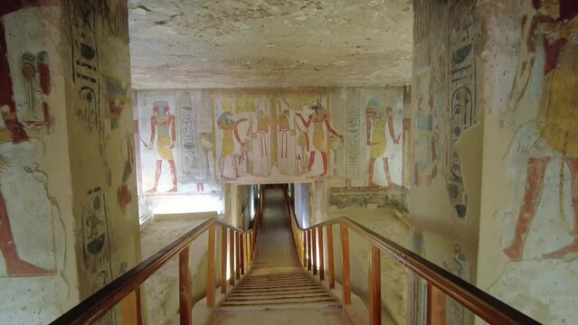 Luxor, Egypt: Hieroglyph and painting in the majestic interior of the famous Ramsses V and VI tomb, named KV9, in the valley of Kings in Luxor in Egypt. Shot with a tilt down motion