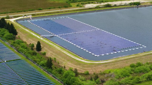 Floating solar panels at renewable electrical power plant for producing clean electric energy. Concept of sustainable photovoltaic electricity on water surface with zero emission