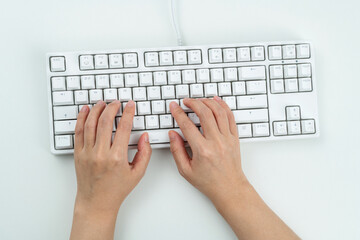 Woman hand tying on computer keyboard
