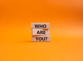 Who are You symbol. Concept words Who are You on wooden blocks. Beautiful orange background. Business and Who are You concept. Copy space. - obrazy, fototapety, plakaty