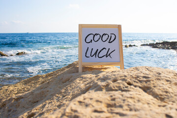 Good luck symbol. Good luck white chalk blackboard. Beautiful sea background. Business and Good...