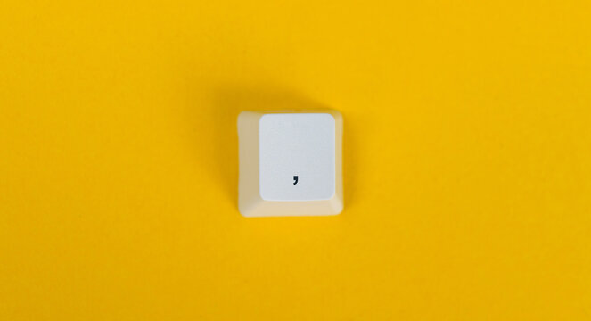 Keyboard comma key on white background