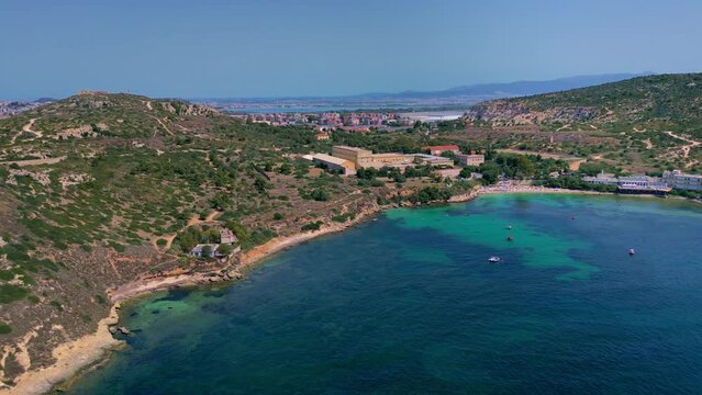Following the sandy coastline along Spiaggia Calamosca beach, in Sardinia, Italy