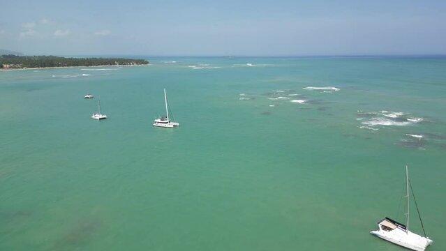 Luxurious boats in the turquoise waters near the beach of Punta Popy in the tourist town Las Terrenas in the Dominican Republic