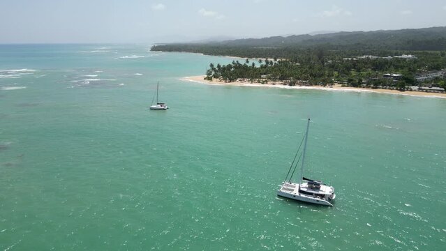 Luxurious catamarans in the turquoise waters at Punta Popy beach in Las Terrenas on the caribbean island of Dominican Republic