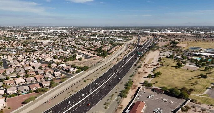 Drone Panning around Highway next to residential houses and park. Highway 202 in South Phoenix Arizona
