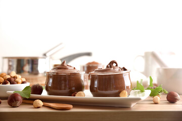 Cocoa cream with hazelnuts and nuts on bench isolated background