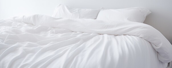 Capture the essence of purity and comfort as a white folded duvet graces the backdrop of a pristine white bed.




