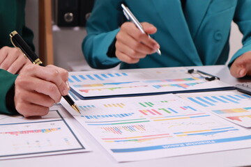 Business Woman accounting discussing financial with calculator and business chart and graph