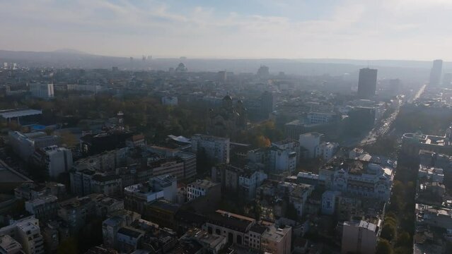 Aerial footage in the haze of the morning flying towards St. Mark Orthodox Church in Belgrade, Serbia.