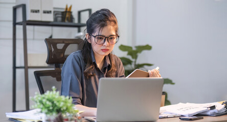 Puzzled confused asian woman thinking hard concerned about online problem solution looking at...