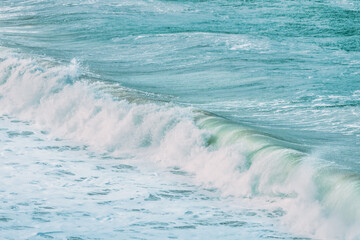 Wave splashing close-up. Crystal clear sea water, in the ocean in San Francisco Bay, blue water, pastel colors.