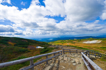 Fototapeta na wymiar Beautiful autumn colors at Mt. Asahidake, Daisetsuzan national park, Hokkaido, Japan. 