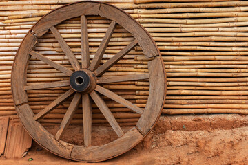 A wheel of a bullock cart just outside of beautiful traditional tribal bamboo cottage or hut at Kanger valley national park, Chattisgarh, India.