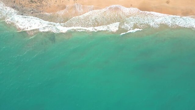 Summer seascape beautiful waves, blue sea water in sunny day. Esquinzo beach, Spain, Canary Island Top view from drone. Sea aerial view, tropical nature Beautiful bright sea waves