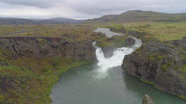 Slow forward drone flight over landscape with river and waterfall in southwest Iceland