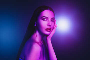 Fototapeta premium Portrait of beautiful woman in neon lights