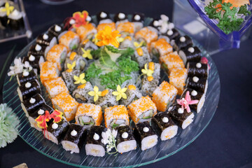 Japanese sushi food dish display. Maki ands rolls with tuna, salmon, shrimp, and crab. Top view of assorted sushi, all you can eat menu. Rainbow sushi roll, uramaki, hosomaki and nigiri.