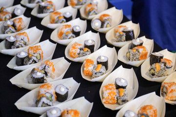 Japanese sushi food dish display. Maki ands rolls with tuna, salmon, shrimp, and crab. Top view of assorted sushi, all you can eat menu. Rainbow sushi roll, uramaki, hosomaki and nigiri.