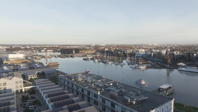 Marina at Bassins &agrave; flot with decommissioned submarine base and UFO Sculpture in daytime, Bordeaux France, Aerial rising shot