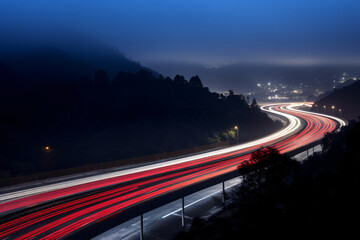 Long exposure of a highway at night with light trails of cars driving past