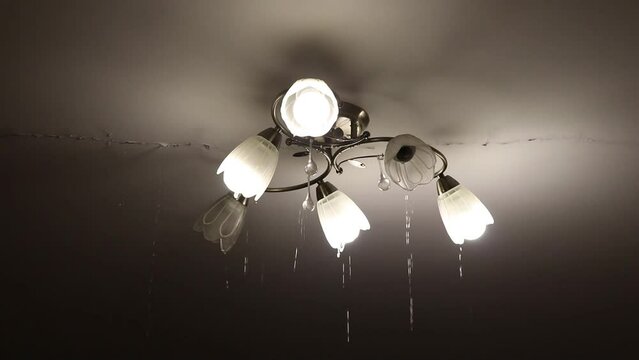 Due to a pipe break, there was a flood in the apartment upstairs and water is flowing from the ceiling and along the chandelier and along the ceiling, the flood in the apartment is flowing from all th