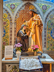 A nun kneels before Jesus