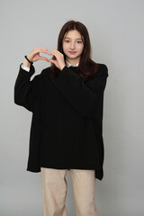 Fashionable Teen in Versatile Black Hoodie: stylish exudes thoughtful and introspective aura,...