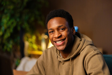Portrait of handsome atractive young african american man wearing casual outfit smiling at camera.