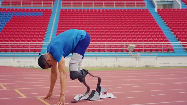 Asian athletes are disabled with prosthetic blades running at stadium. 