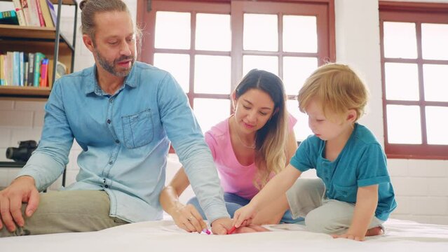 Caucasian family spend leisure time with baby boy in bedroom at house. 