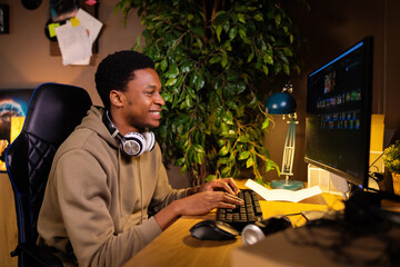 Delighted curious handsome African American gguy software developer, collaborating with a remote...