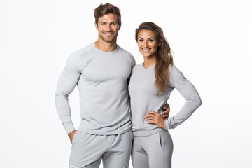 A fit and happy couple, wearing winter thermals, engages in athletic training, showcasing strength...
