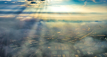 Aerial view of Saigon cityscape at morning with misty sun rays sky in Southern Vietnam. Urban...