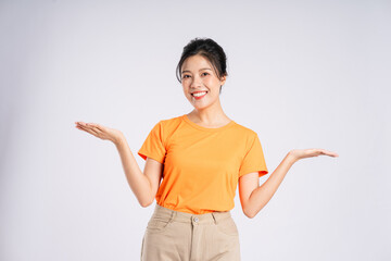 Portrait of cheerful happy Asian woman posing on white background