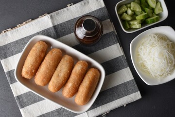 Pempek  on white plate with vermicelli and cuko sauce. Pempek, mpek-mpek or empek-empek is a savory Indonesian fishcake delicacy, made of fish and tapioca, from Palembang, South Sumatera, Indonesia.