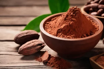 Badkamer foto achterwand Cocoa powder in a bowl and cocoa beans on wooden background © Giuseppe Cammino