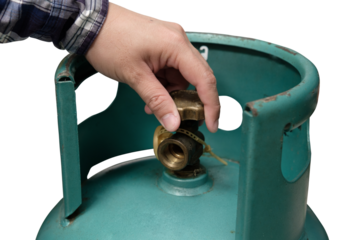 Male hand is closing the valve of lpg gas tank for safety. Files can use clipping parts.