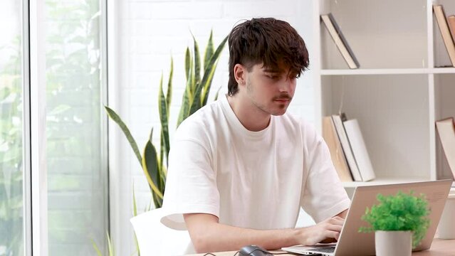 young man with laptop reacting happy celebrating