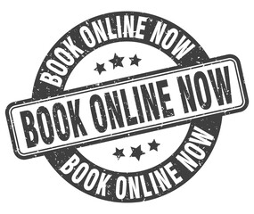 book online now stamp. book online now label. round grunge sign