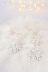 White snowflakes on fur background. Christmas and New Year decoration