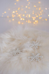 White snowflakes on fur background. Christmas and New Year decoration