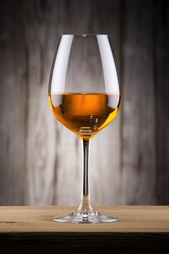 Glass of sherry wine on wooden surface