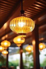 focus on beautiful modern style, gold color lantern light hanging on the ceiling in the restaurant...