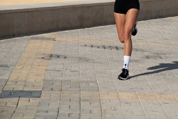 Person running on marathon racing. People exercising outdoors. Healthy lifestyle.