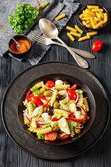 fusilli salad with mozzarella, veggies in a bowl